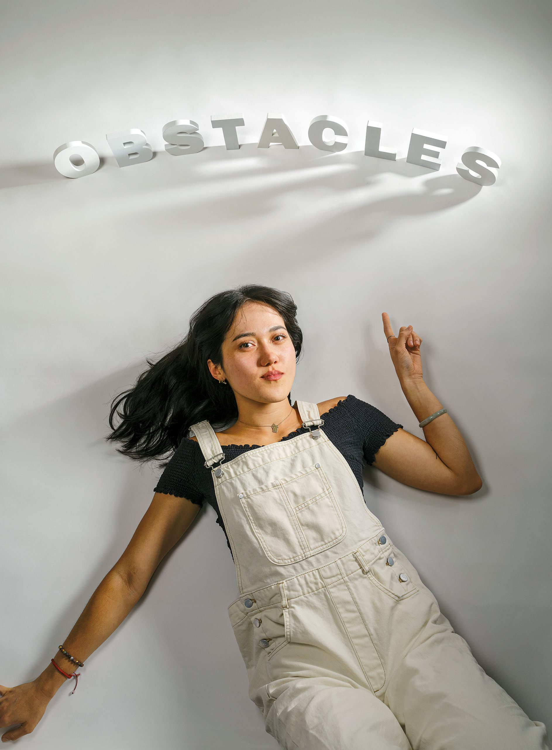 Heidi Erwin points to letters that spell out Obstacles